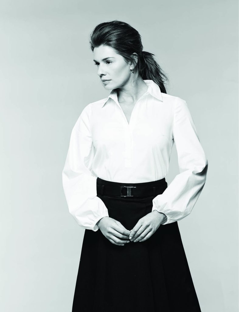Drama Sleeve poplin shirt, $88: White House Black Market. Belted stretch cotton skirt, $150: Michael Kors North Park Center. Trina Turk earrings, $40: Belk.