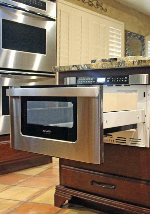 This sliding under-counter microwave neatly rolls out of sight. Photo courtesy Sam Ferris, Tukasa Creations.